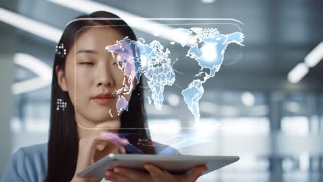 woman using a tablet with a world map hologram