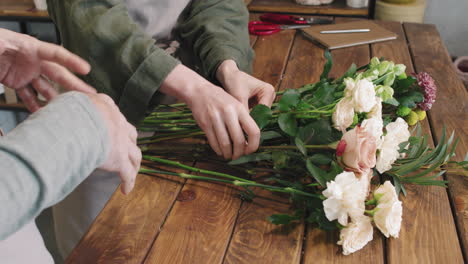 florists creating bouquet of flowers