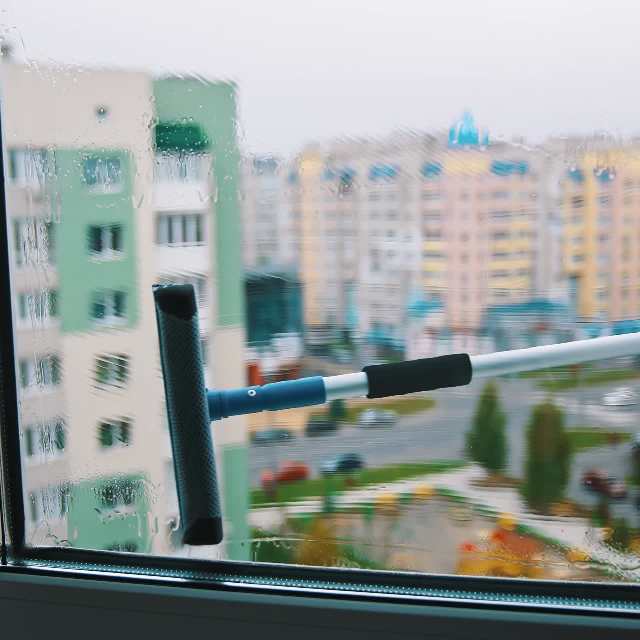 Water cleaner with wet glass. Close up view of cleaning wet window