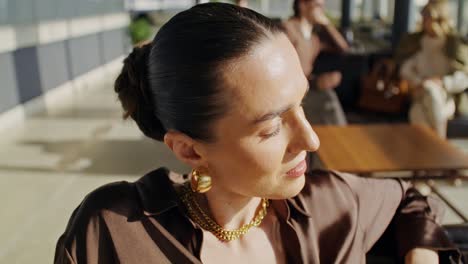 stylish woman relaxing in airport lounge