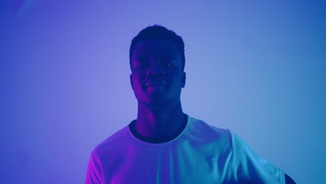 portrait of young african footballer in studio junior afro-american sportsman with football ball