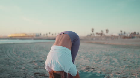 caucasian girl doing stretching exercises outdoors.