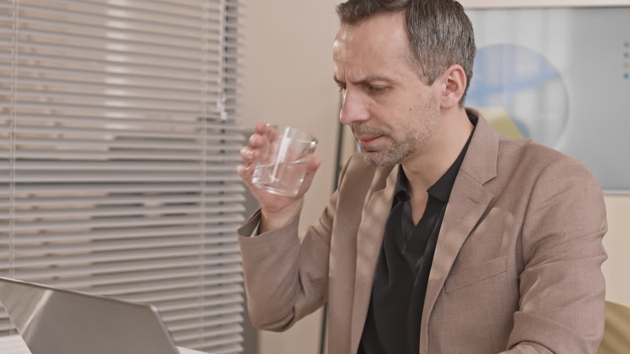Businessman Working and Drinking Water