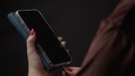 detailed close-up shot of a smartphone in hand, ready to charge. the lighting is soft and atmospheric, enhancing the device's sleek design against a blurred background, highlighting everyday tech use