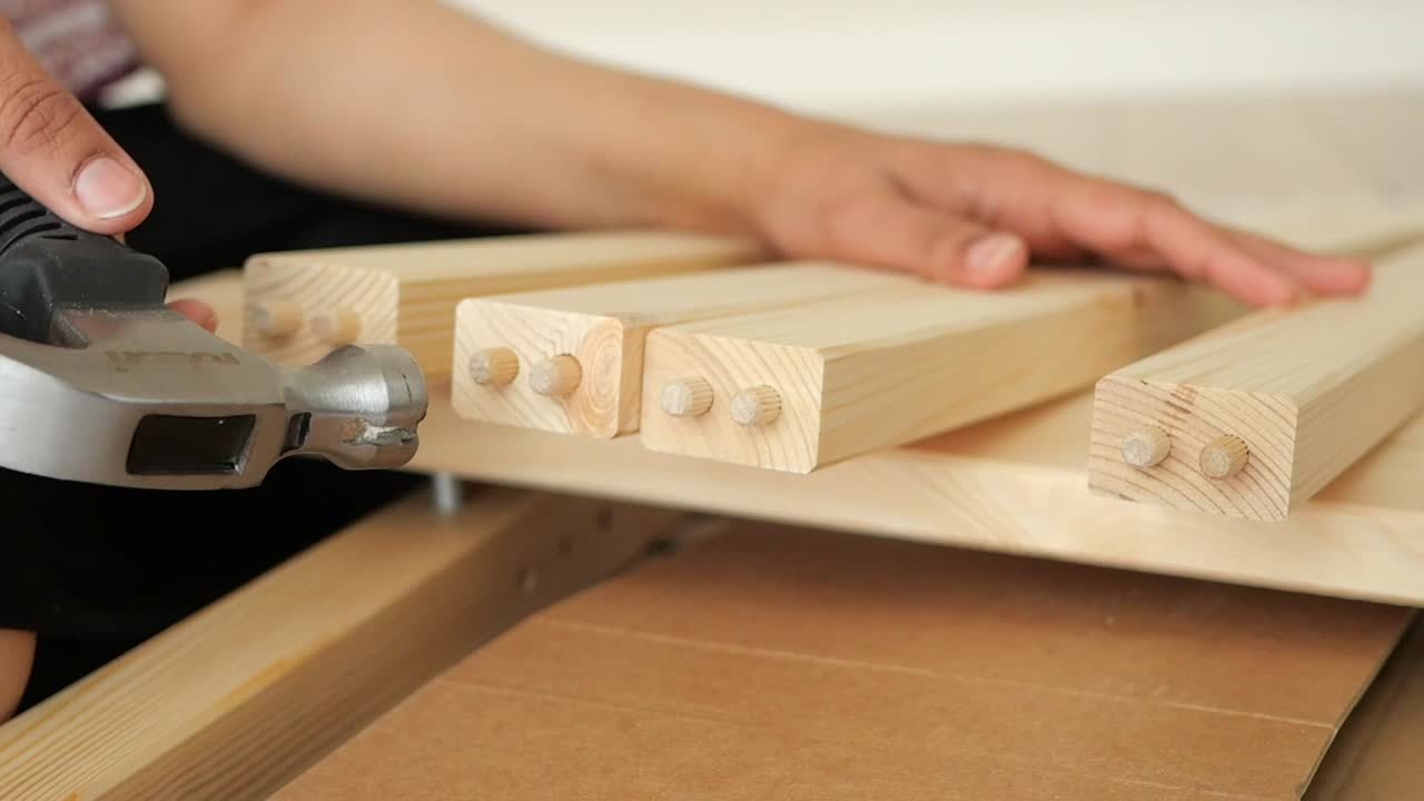 Assembling wooden furniture with hammer and dowels