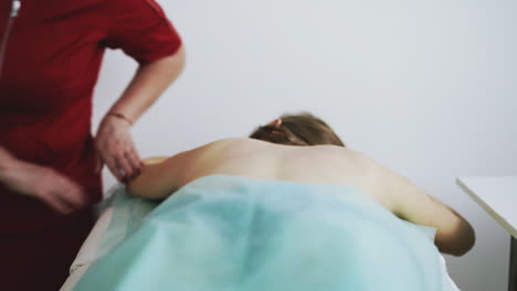 plump-doctor-does-classical-massage-procedure-of-girl-back