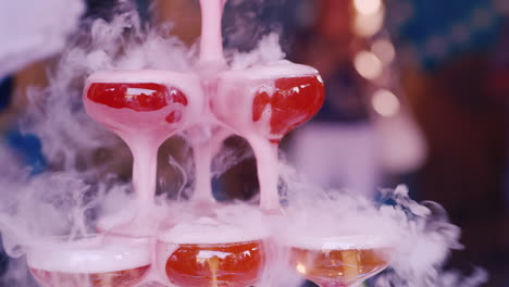 hand of the waiter in white gloves pour steaming champagne at a party