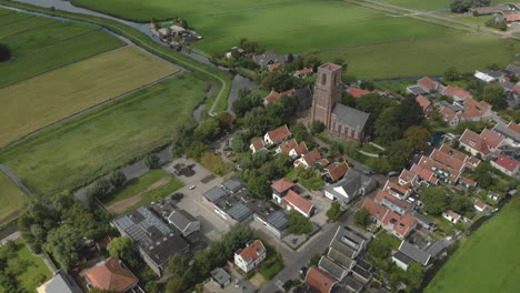 aerial rotating pan around the centre of the village ransdorp with its agrarian surroundings near the city of amsterdam in the netherlands with clouds