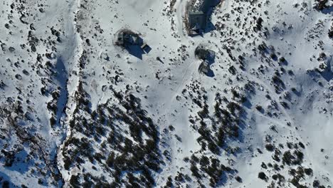 Drone-top-shot,-icy-lake,-Rila-mountain,-winter,-sunny-day,-woods