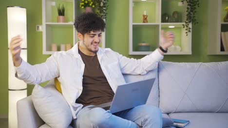young man happily hugging laptop.