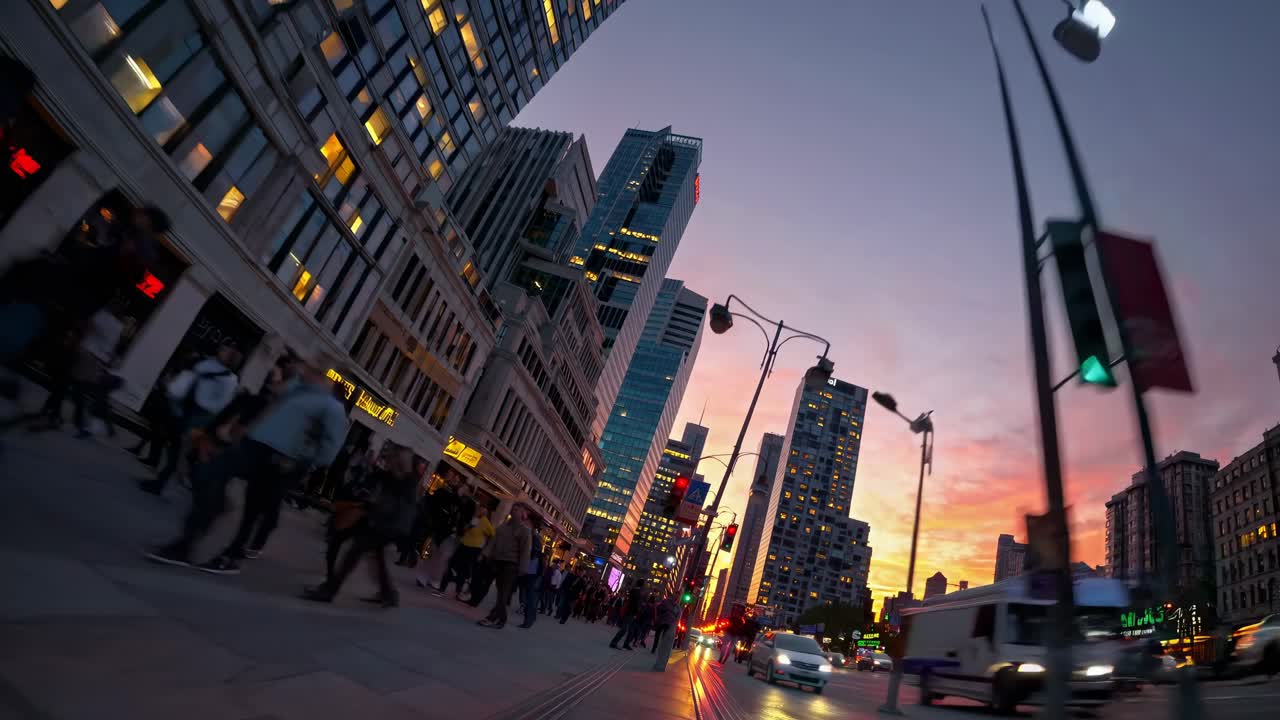Dynamic cityscape at dusk with a low-angle view, capturing blurred pedestrians and vibrant lights