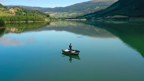 Una-Mujer-En-El-Barco-Pesca-Un-Pez-Girando-En-Noruega.