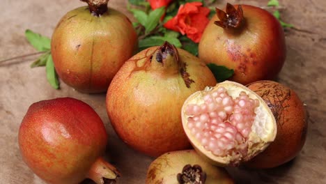 ruby pomegranate grains in a wooden bowl on a rustic table