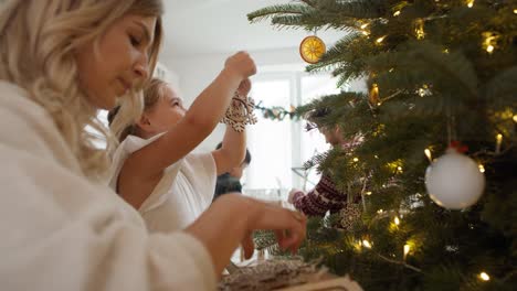 family decorating home for christmas