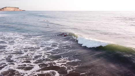 surfistas remando en el océano con olas rompientes cerca de la playa de olon en verano