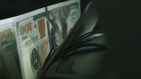 close-up of us dollars in a counting machine