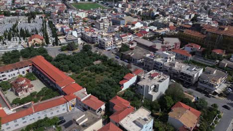 aerial , high angle view of historic center of kalamata, tilt up drone movement , revealing wide cityscape and messinian bay on background 4k