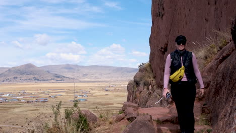 witness a tourist capturing the breathtaking landscape from the mirador region at the mystical aramu muru portal archaeological site in peru