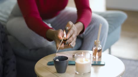 aromatherapy table setting with perfumed candles, oil burner and mood reeds in natural window light, dolly slider shot, shallow dof