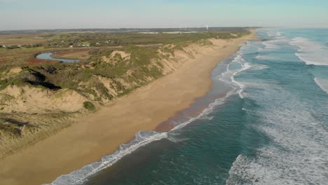 Aerial-shot-up-high-of-waves-crashing-into-shore-at-Powlet-river-in-Victoria-Australia