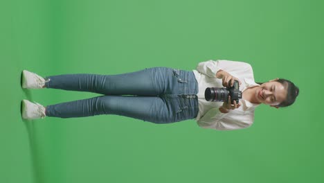 woman holding a camera in a studio