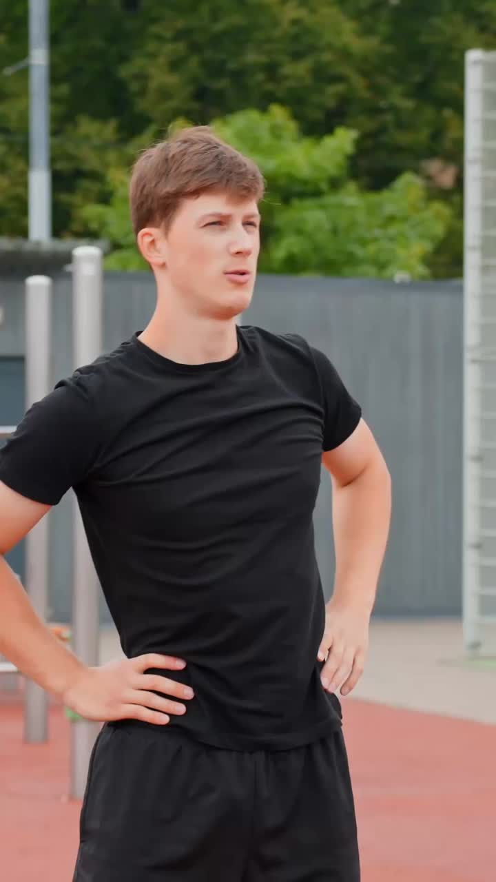 Man Warming Up Doing Hip Circles Before Working Out In An Outdoor Gym. - vertical shot