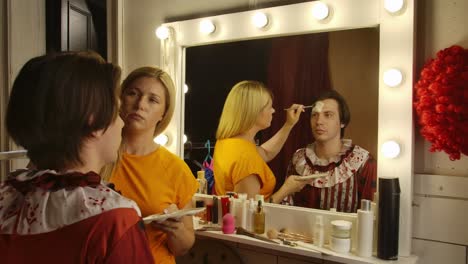 makeup artist applying clown makeup for a halloween event