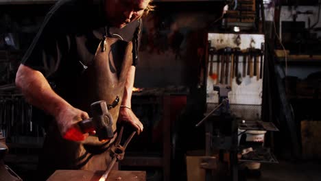 blacksmith working on a iron rod