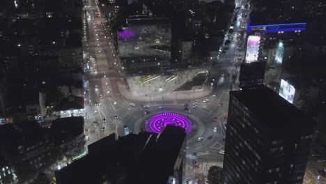 aerial shot of a city square with a lot traffic on a roundabout