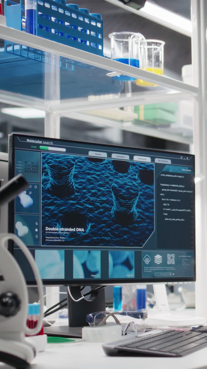 Vertical video Research facility workstation with computer monitor displaying DNA data