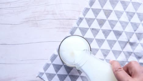 pouring milk into a glass