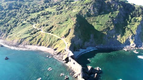 Aerial-view-of-San-Juan-de-Gaztelugatxe-church-with-zigzag-stairs-in-Cantabrian-Sea