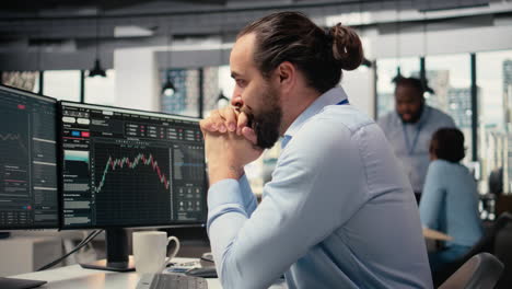 happy portfolio manager in office celebrates positive investment returns
