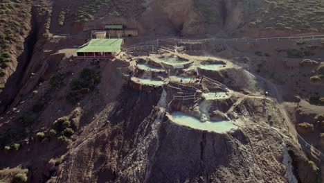 vista aérea de las piscinas de aguas termales de termas valle de colina en cajon del maipo, chile - disparo de drones