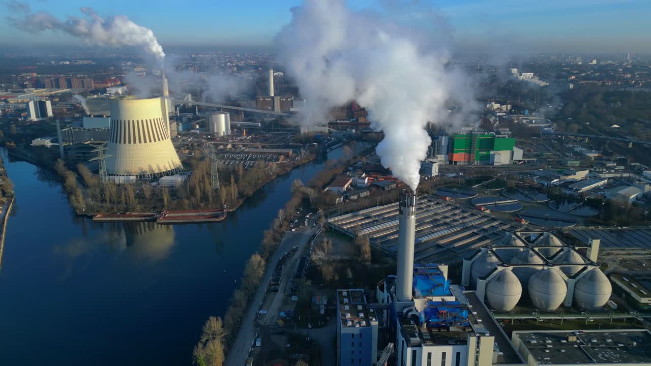 Industrial chimneys releasing large plumes of smoke pollution into the atmosphere, contributing to environmental damage. speed ramp hyper motion time lapse Majestic aerial view fly push forward drone