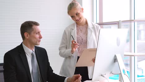 two business people talk project strategy at office