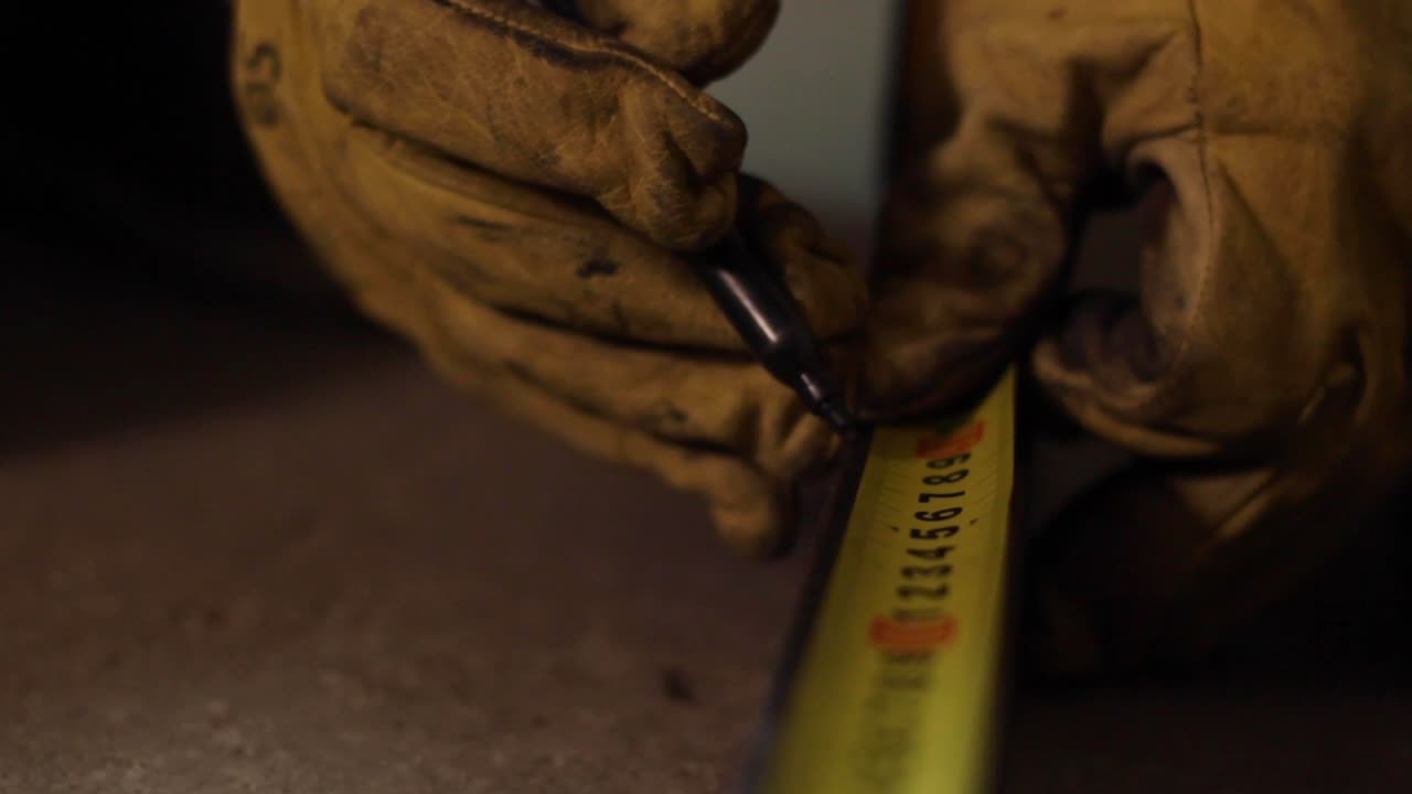 Measurement reading markings being made on a tape, closeup