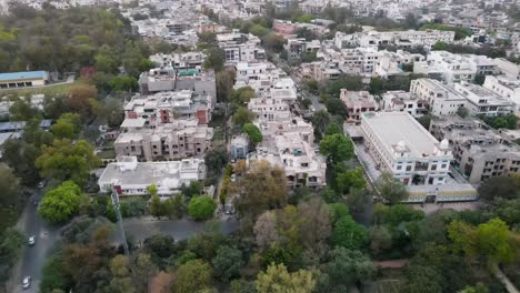 4K-Drone-Shots-of-a-Sunset-in-an-Indian-City-New-Delhi-above-trees-and-houses-beautiful-light-punjabi-bagh-club-posh-colony