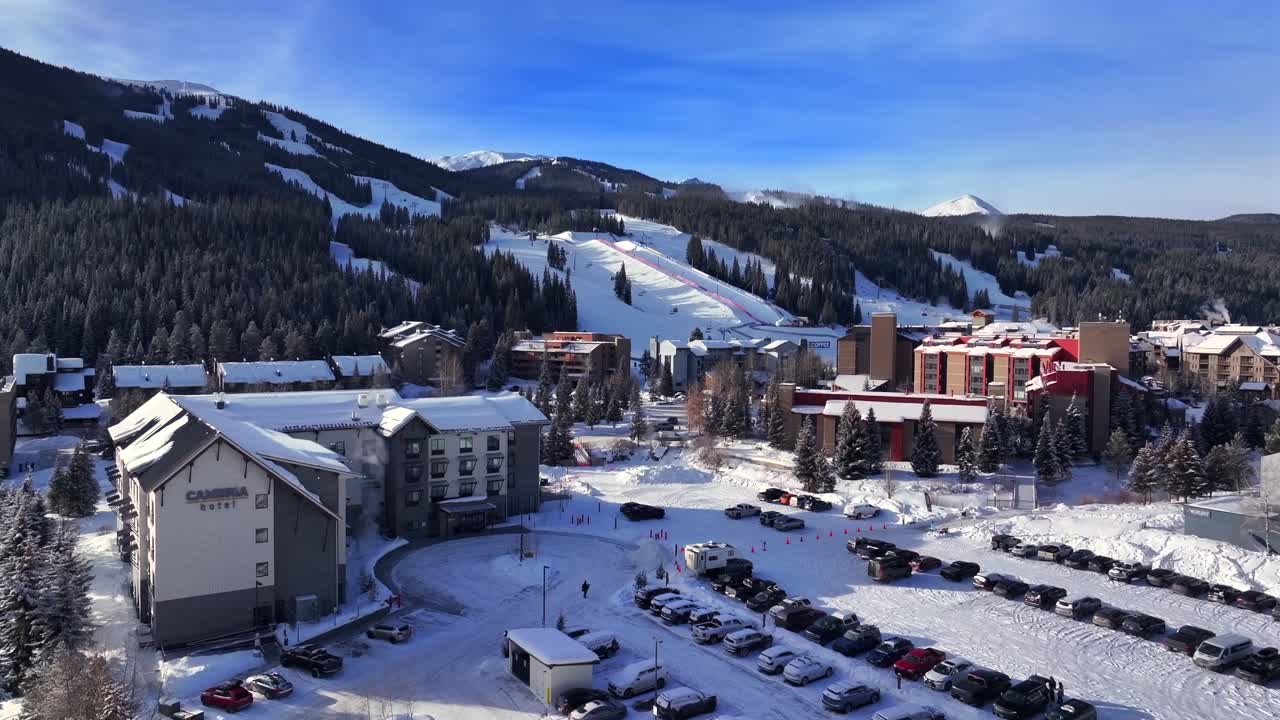 Copper Mountain Ski Resort parking lot center village aerial drone view chairlifts gondola Ikon Pass Alterra snowboarding snow skiing riding trails morning winter solstice December trees upward motion