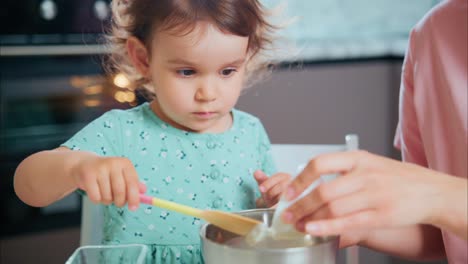 engaging moments: a young child learning to cook together with a parent, mixing ingredients in a bowl, creating lasting memories in the kitchen