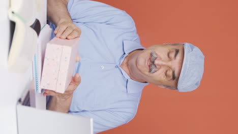 vertical video of happy and joyful old man opening gift package.