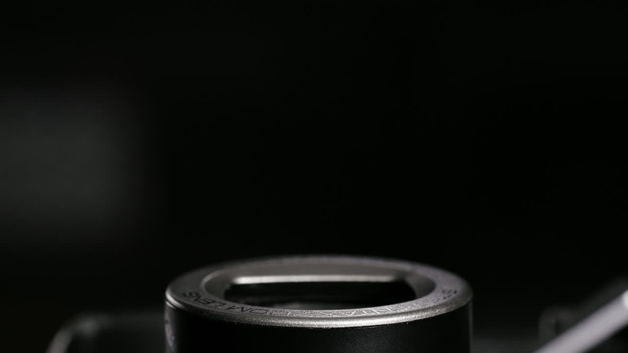 Black and silver point and shoot zoom barrel fully extending and retracting close-up