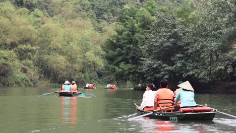 group of people rowing boats on a tranquil river