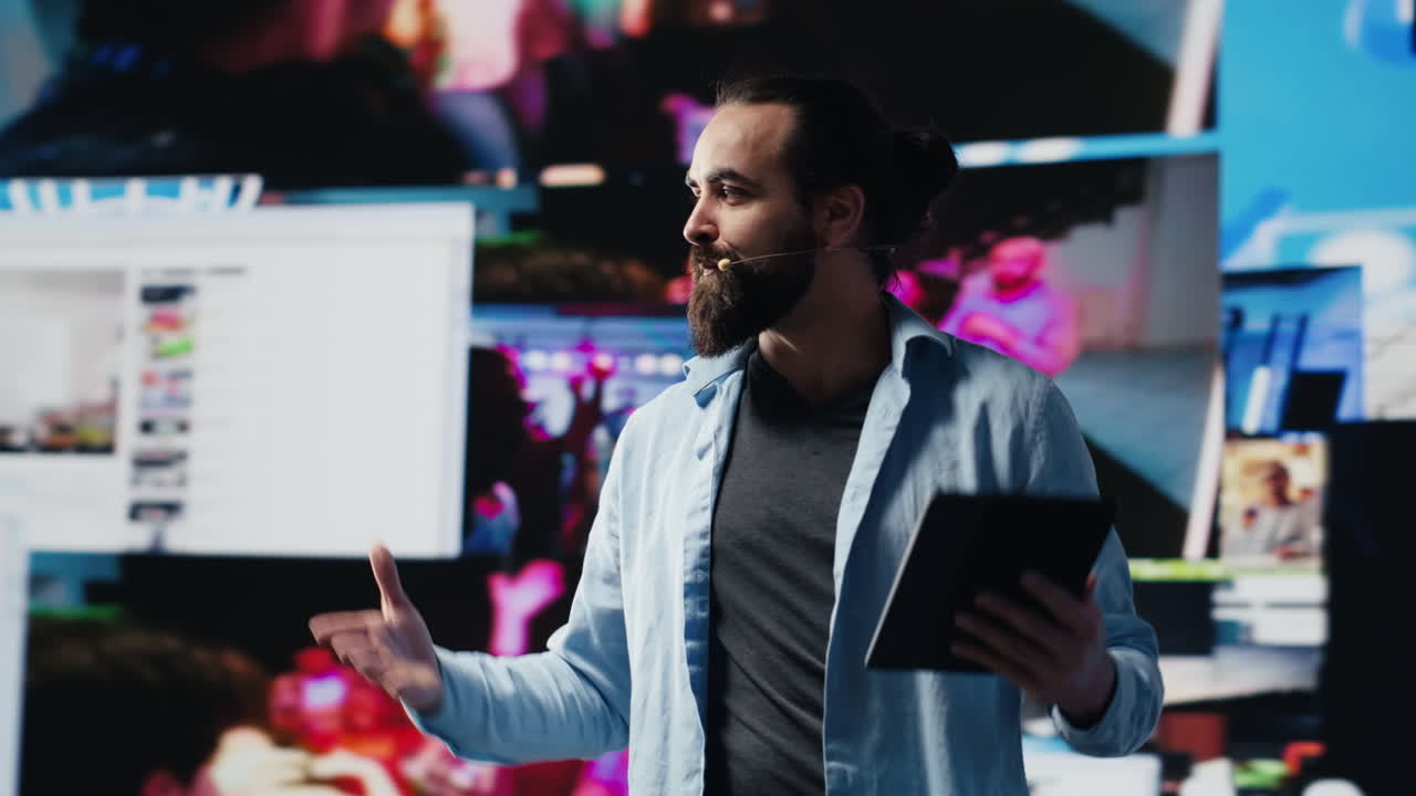 Male cool IT expert hosting a live convention with hands free microphone