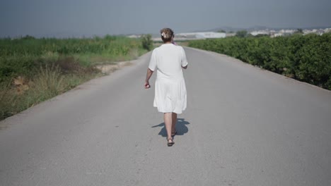 woman walking down a country road