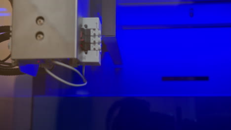 close-up view of industrial machine components under blue light