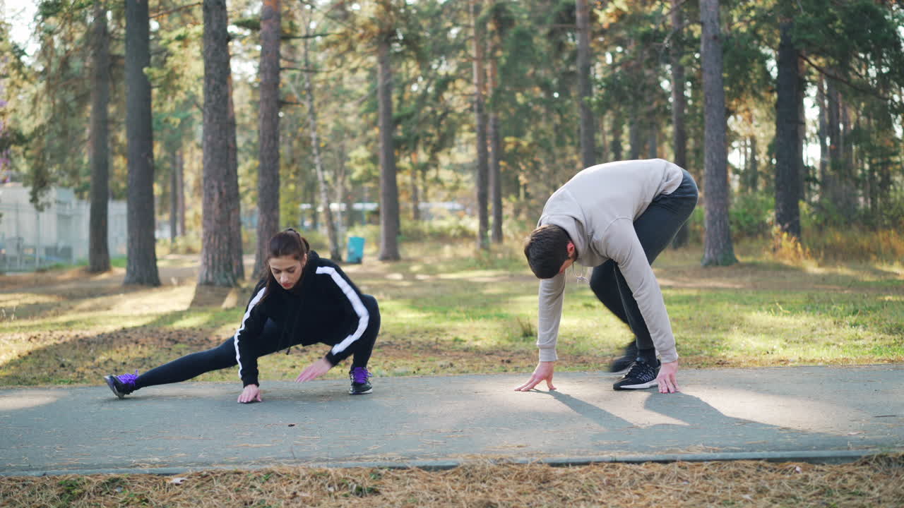 Couple Stretching Outdoors in a Park