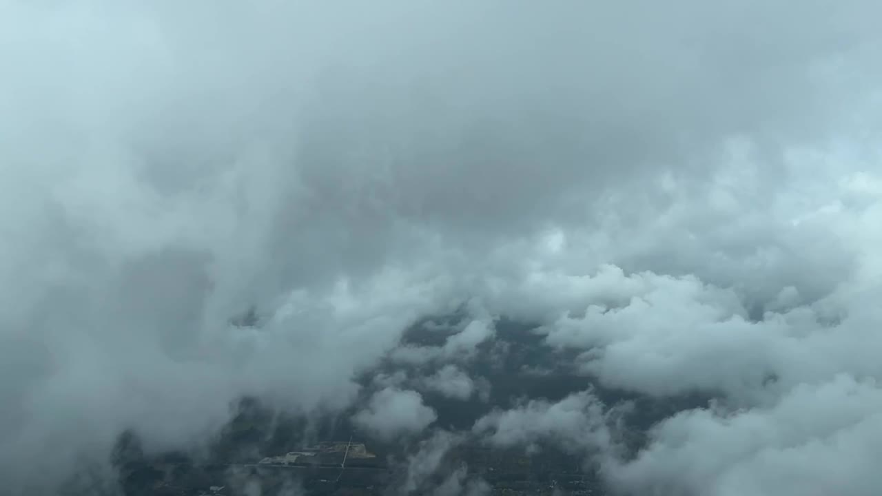 Cockpit view flying through the clouds during an approach in a stormy sfternoon