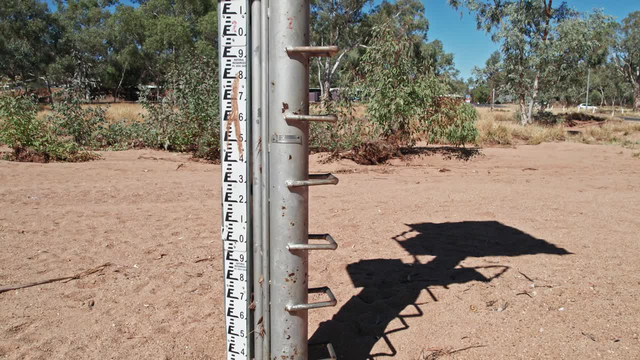 Close up and slowly rising and panning down footage of the stream gauge on the Todd River at Heavitree Gap (station G0060126), Alice Springs, Mparntwe. Northern Territory, Australia. August 2022.