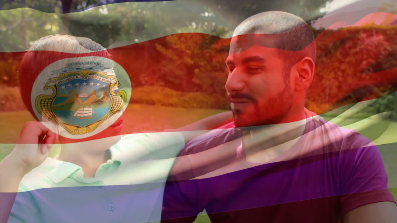 Sitting together in park, two people with Costa Rica flag animation overlay